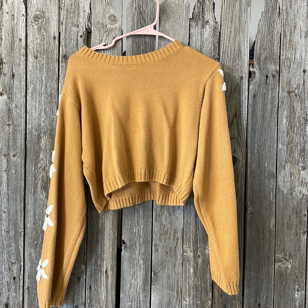 Small, cropped, Altar’d State sweater with knit flowers on the sleeves
